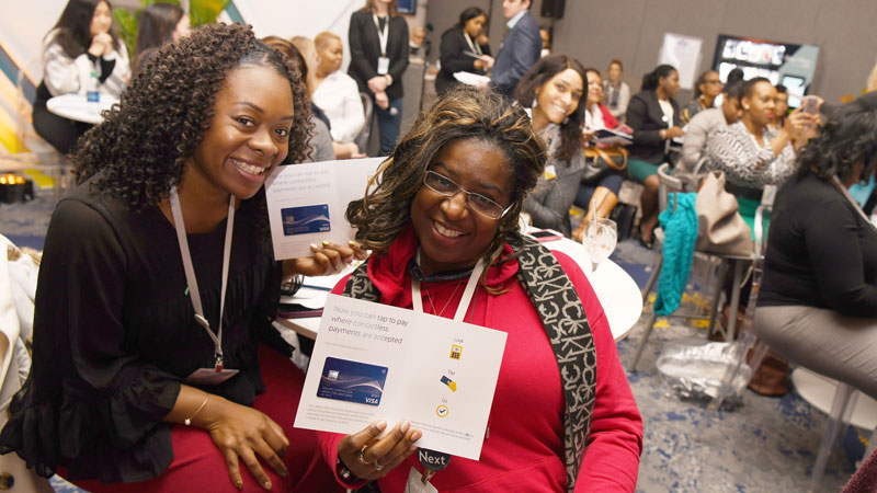She's Next, Empowered by Visa A pair of women smile for the camera at a Visa event